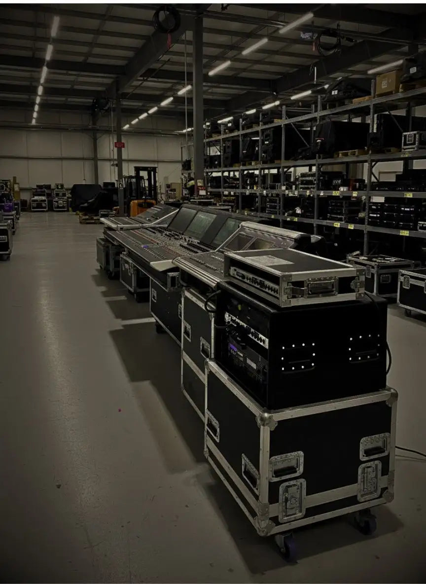 Black and silver professional audio mixing console housed in a protective flight case with wheels.