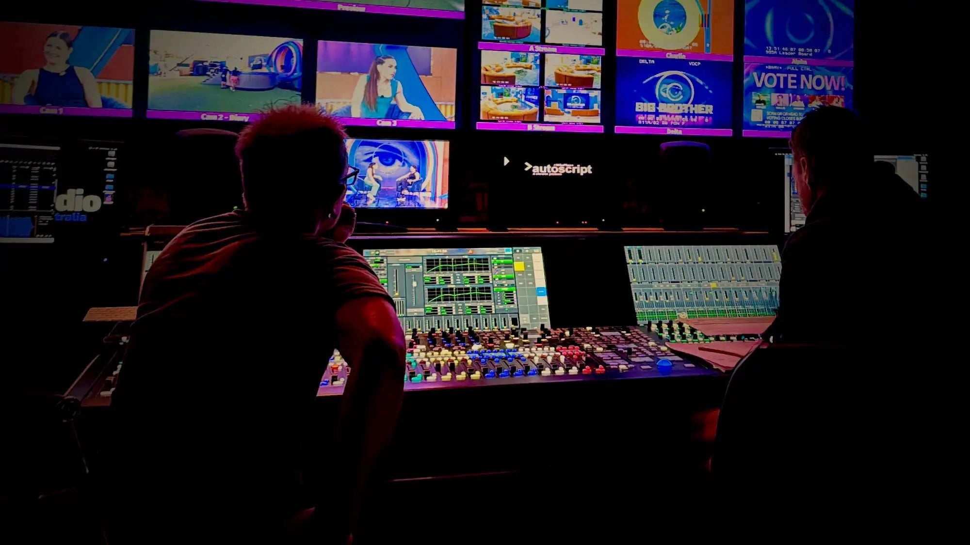 A sleek, multi-monitor television production control room with glowing screens displaying vibrant graphics and live feeds.